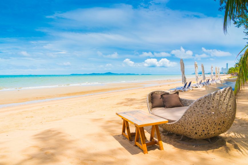 Chair and table dinning on the beach and sea with blue sky background